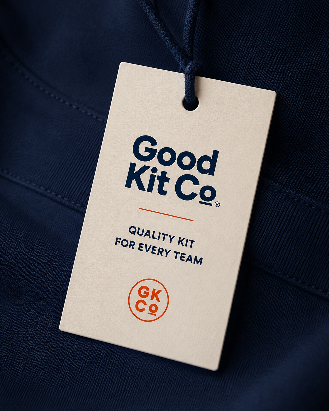 Good Kit Co swing tag on a navy garment